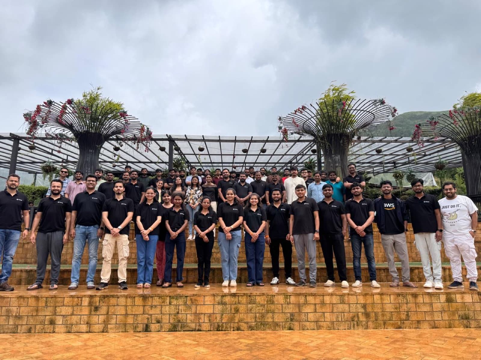 The Flentas team gathered outdoors in matching black T-shirts