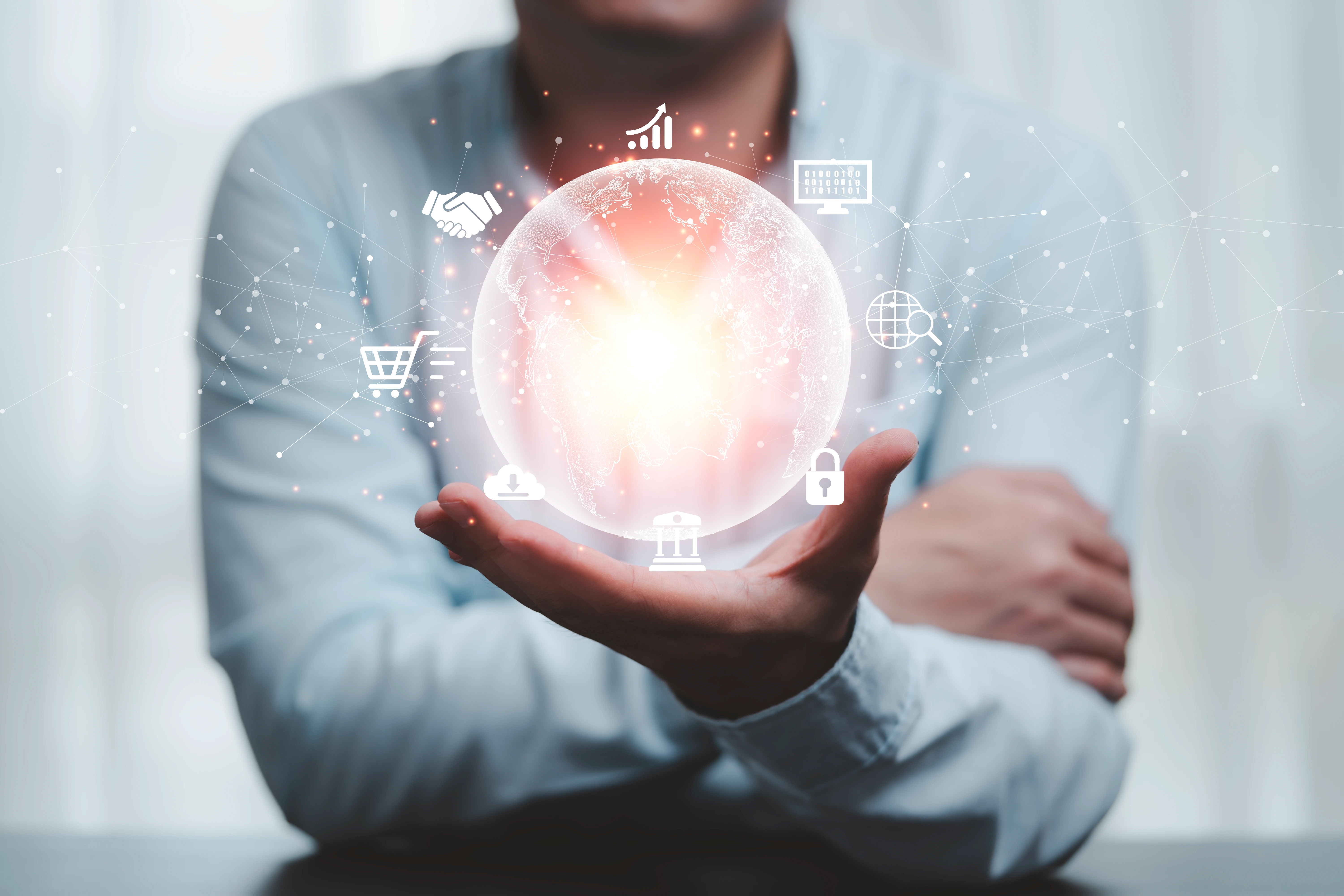 A man is shown holding a globe that is surrounded by fintech trends.